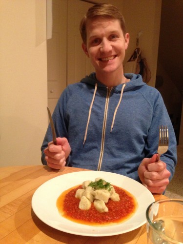happy fiance with gnocchi in tomato sauce