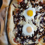 Prosciutto, Caramelized Onion, Mushroom, and Gorgonzola Pizza with an Egg on Top